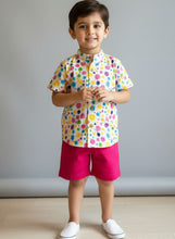Load image into Gallery viewer, Child wearing a colorful splash of dots on a shirt with pink shorts, cotton fabric, extremely comfortable, great to play with on Holi