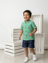 Load image into Gallery viewer, Child wearing cotton shirt, green stripes with red hearts, and blue denim shorts