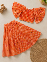 Load image into Gallery viewer, 3-year-old girl wearing an orange gingham cotton crop top lehenga with floral prints, layered ruffle sleeves and an ankle-length skirt.