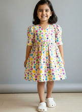 Load image into Gallery viewer, Young girl wearing a colorful splash of paint on a cream colour frock. Holi outfit ideas, cotton print 
